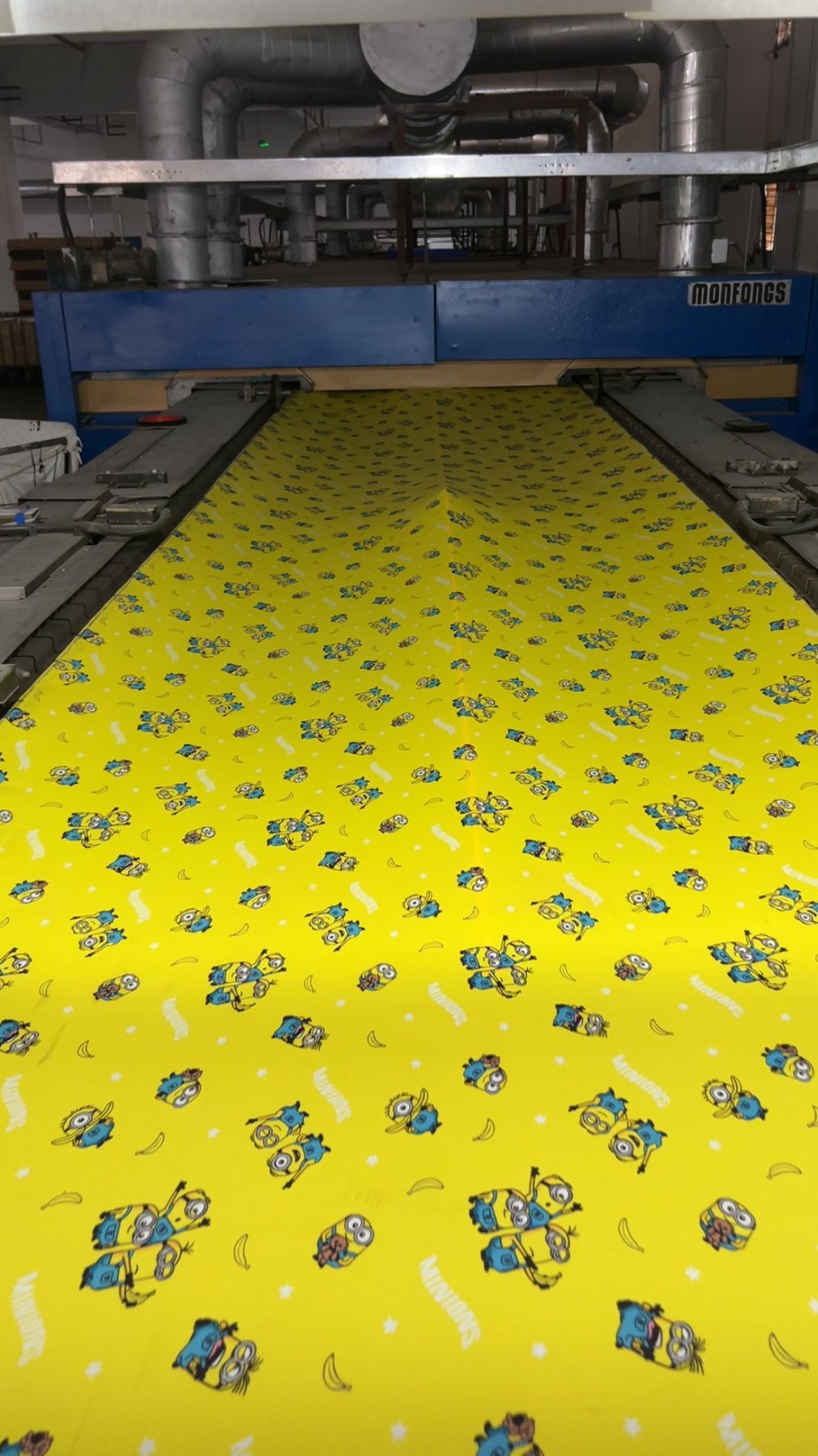 Printed fabric passing through a digital printing and finishing machine