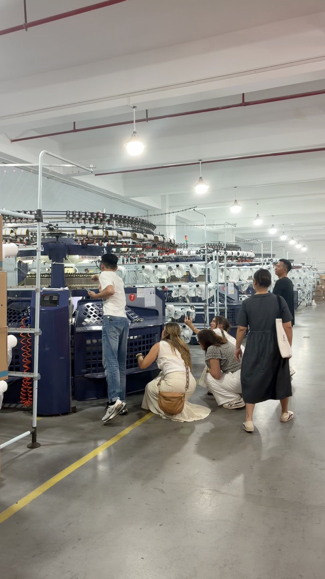 People working beside textile machinery
